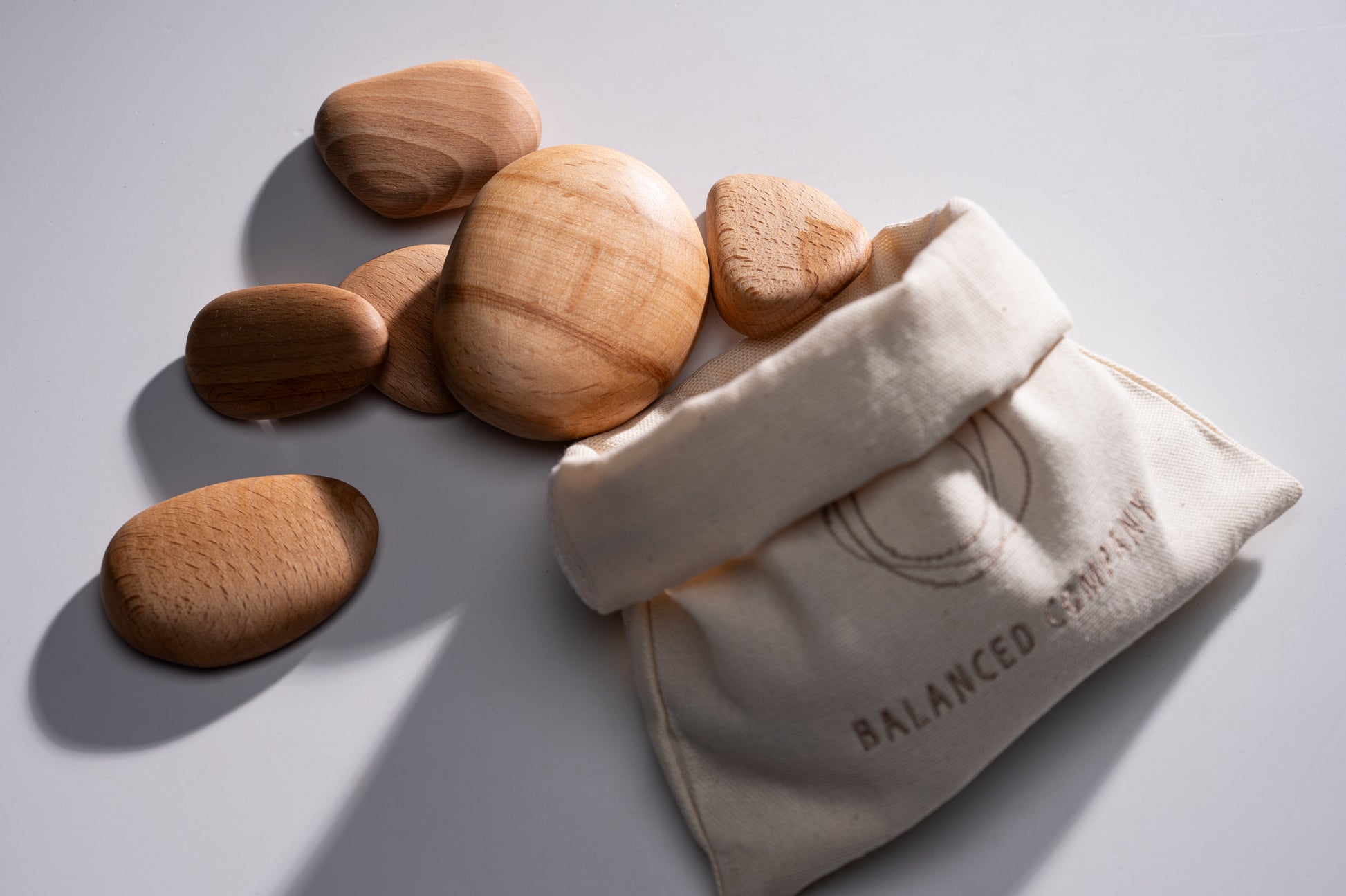 A stack of wooden pebbles next to the fabric