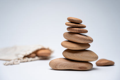 A stack of wooden pebbles next to the fabric